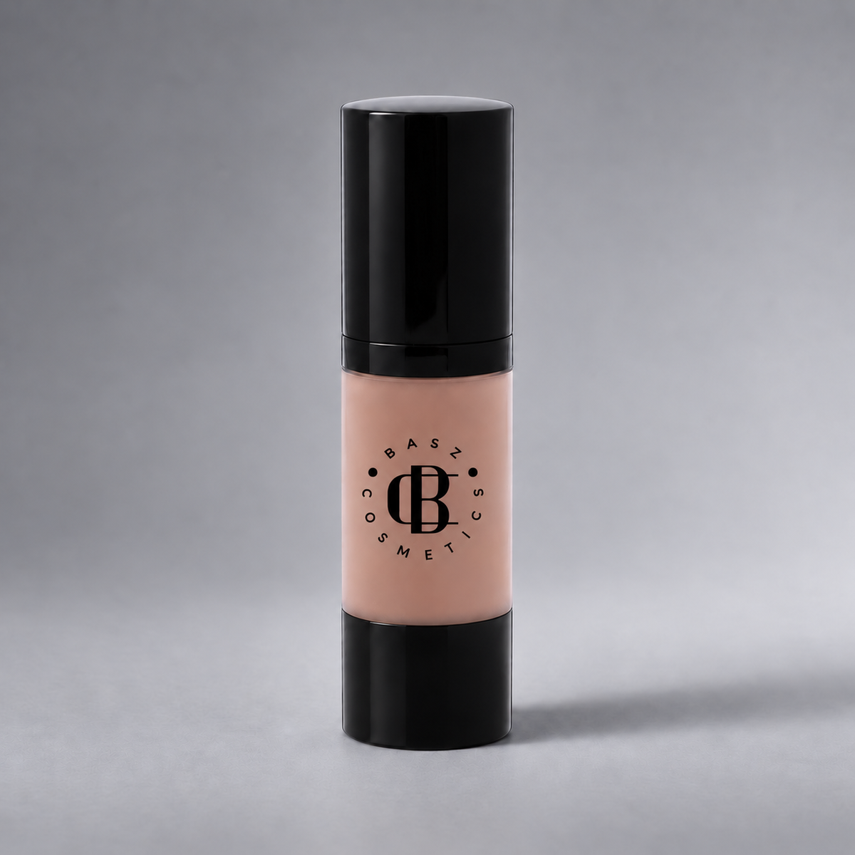 BaszCosmetics Bare It All Liquid Foundation — Beige Babe (103), black logo on gray studio background