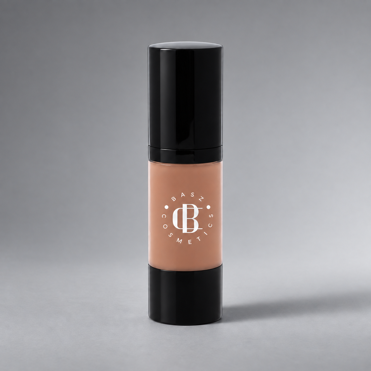BaszCosmetics Bare It All Liquid Foundation — Bronzed Babe (104), white logo on gray studio background