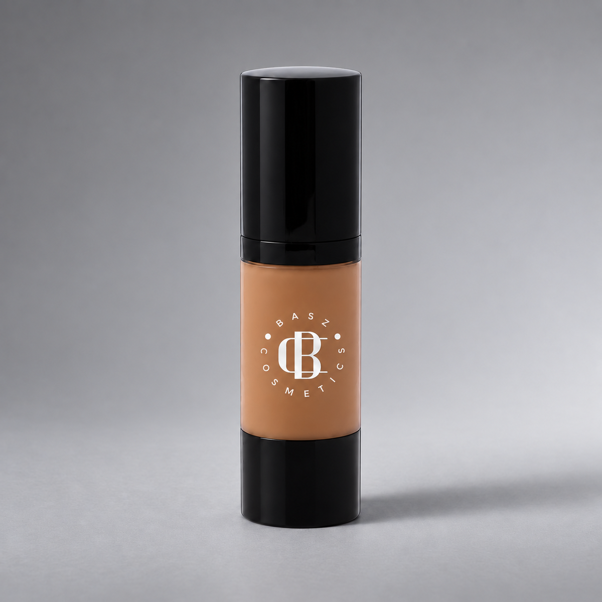 BaszCosmetics Bare It All Liquid Foundation — Mocha Muse (105), white logo on gray studio background