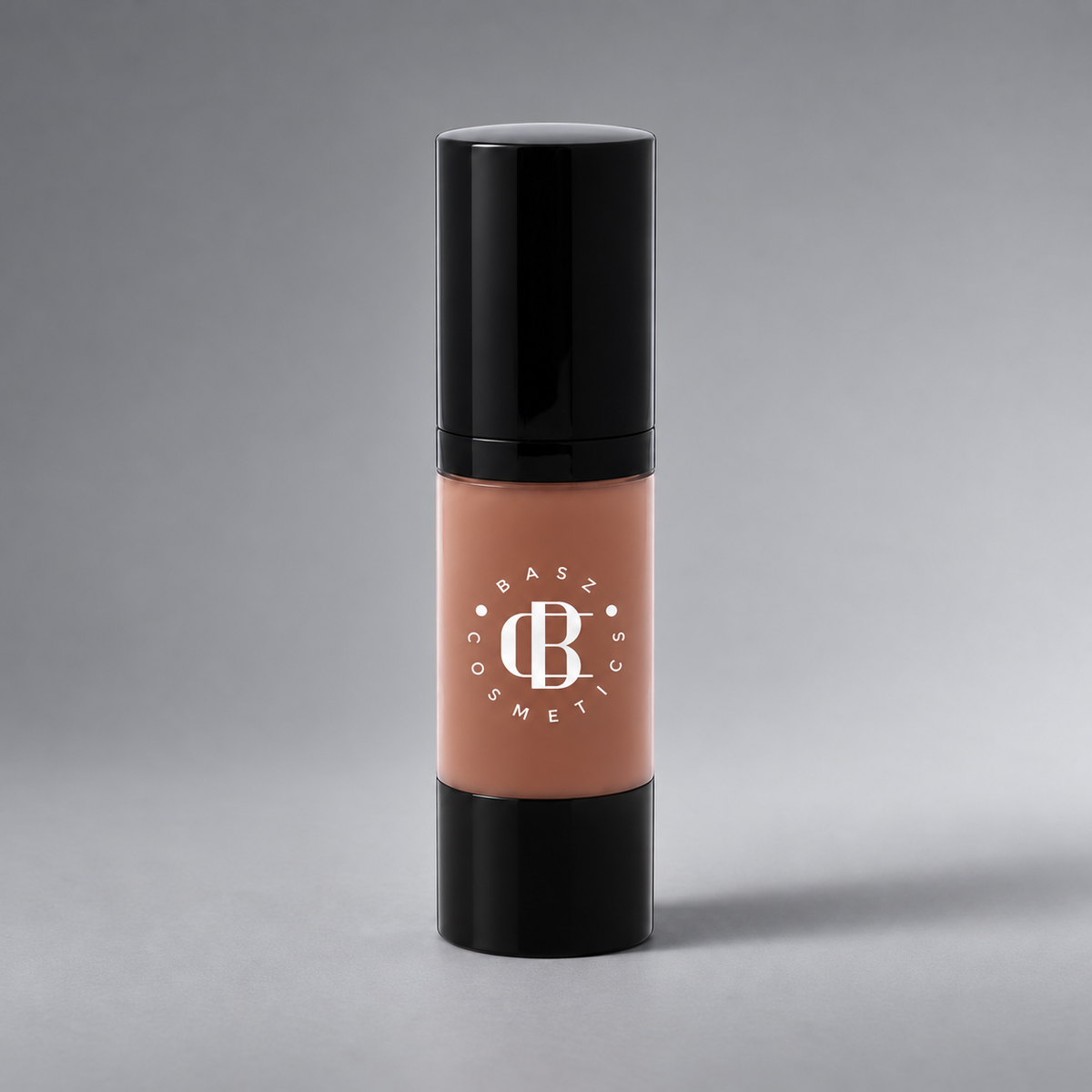 BaszCosmetics Bare It All Liquid Foundation — Caramel Crush (107), white logo on gray studio background