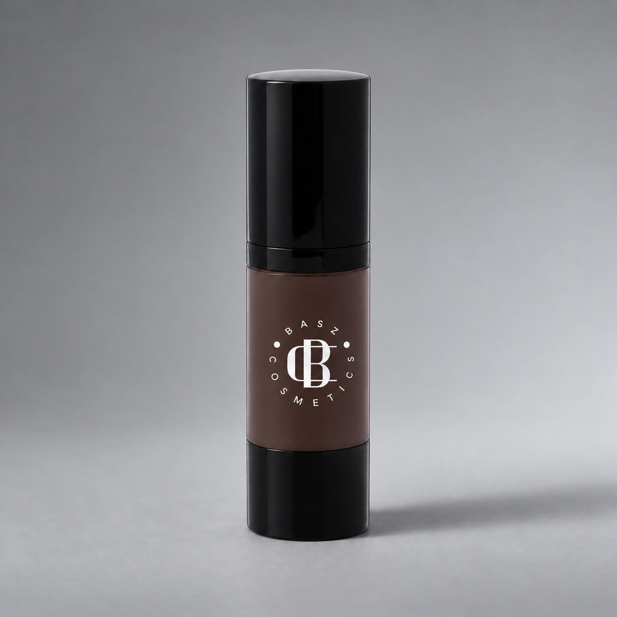 BaszCosmetics Bare It All Liquid Foundation — Cocoa Crush (113), white logo on gray studio background