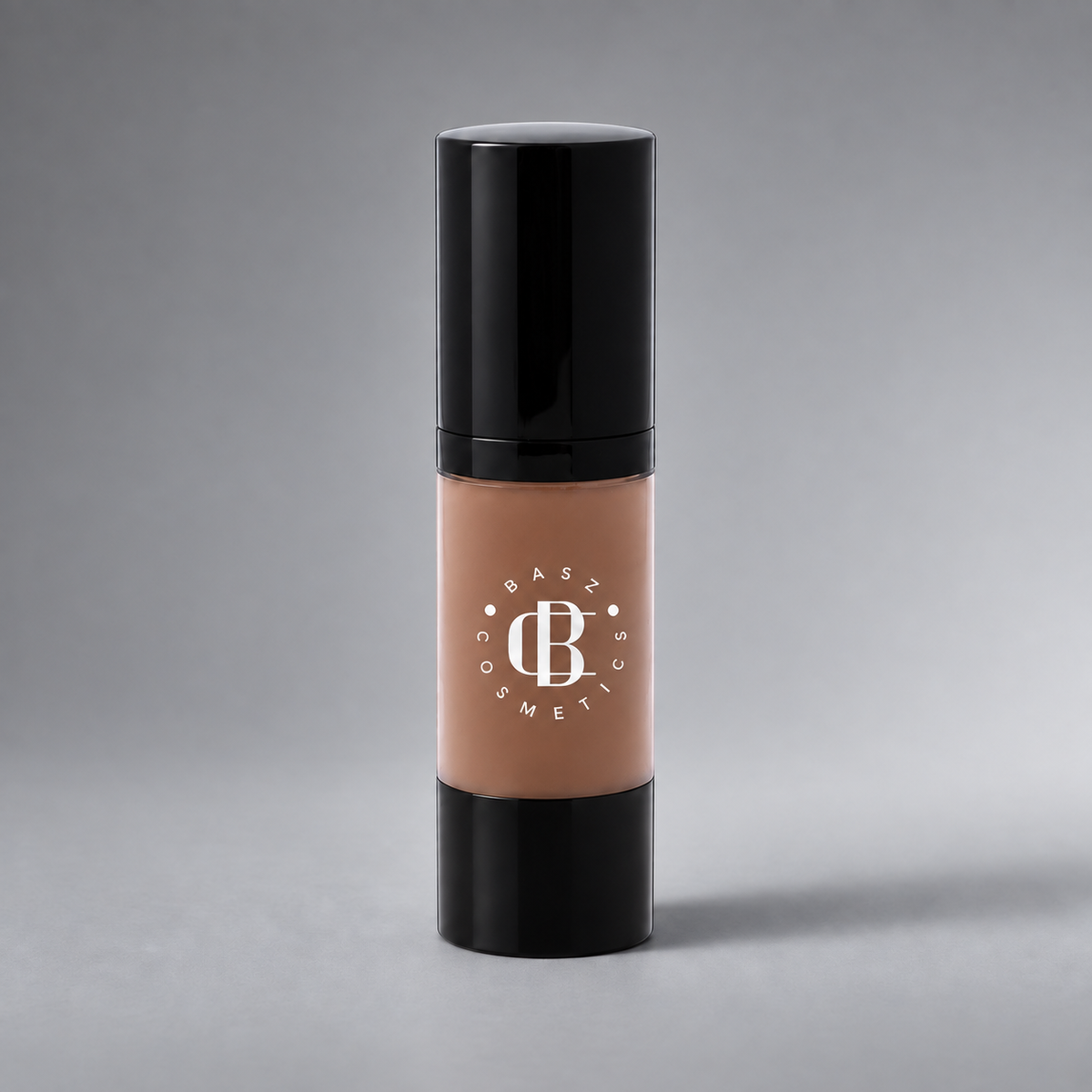 BaszCosmetics Bare It All Liquid Foundation — Almond Allure (155), white logo on gray studio background