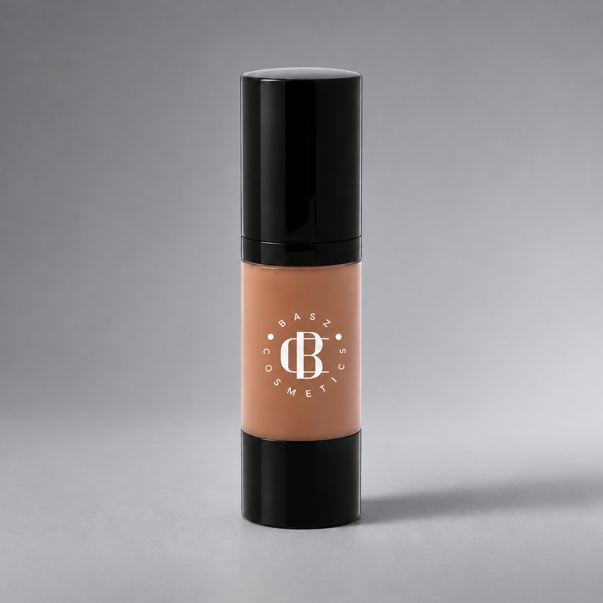BaszCosmetics Bare It All Liquid Foundation — Honey Hustle (156), white logo on gray studio background